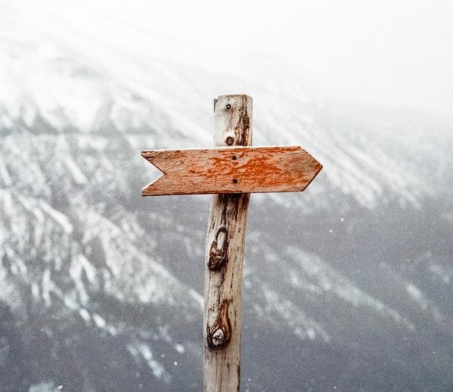 Brown wooden arrow sign